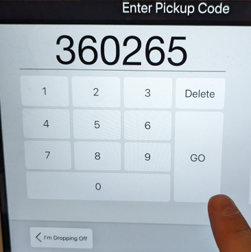 A finger pointing at a screenDescription automatically generated